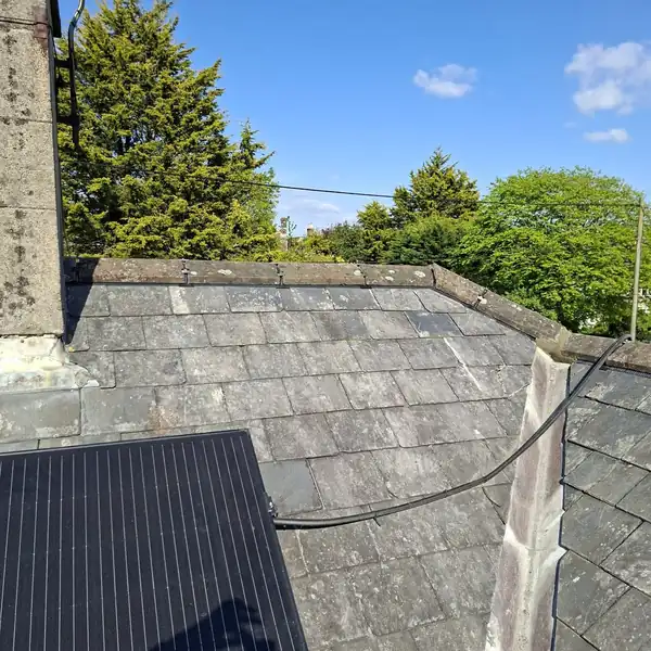 Slate roof with solar panels and lead valley, photographed from the scaffold during a repair
